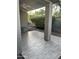 Covered patio with neutral-toned tile flooring and desert landscaping views at 7052 E Kessler Ave, Mesa, AZ 85209