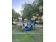 Community playground featuring colorful equipment and mature trees at 7052 E Kessler Ave, Mesa, AZ 85209