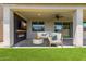 Relaxing outdoor living space with fireplace, tv, and stylish seating area for comfortable outdoor entertainment at 7413 S 32Nd Dr, Phoenix, AZ 85041