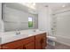 Bathroom boasting a double sink vanity and bathtub with shower at 7413 S 32Nd Dr, Phoenix, AZ 85041