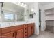 Bathroom featuring double sink vanity, large mirror, and a separate shower at 7413 S 32Nd Dr, Phoenix, AZ 85041