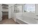 Bright bathroom featuring a bathtub, shower, and closet at 7413 S 32Nd Dr, Phoenix, AZ 85041