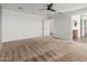 Spacious carpeted bedroom showcasing ample natural light and attached bathroom at 7413 S 32Nd Dr, Phoenix, AZ 85041
