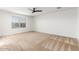 Cozy bedroom with a ceiling fan and large window at 7413 S 32Nd Dr, Phoenix, AZ 85041