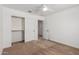 Bedroom with a ceiling fan, closet, and neutral carpet at 7413 S 32Nd Dr, Phoenix, AZ 85041