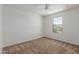 Bright bedroom featuring a window with exterior views and carpeted flooring at 7413 S 32Nd Dr, Phoenix, AZ 85041