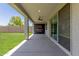 Relaxing covered patio boasts an outdoor TV with an expansive backyard view, perfect for entertaining at 7413 S 32Nd Dr, Phoenix, AZ 85041