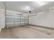 Spacious garage with an automatic door, concrete floor, and ample room for parking and storage at 7413 S 32Nd Dr, Phoenix, AZ 85041