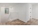 Bright hallway features neutral carpet and paint, white railing, and a window for natural light at 7413 S 32Nd Dr, Phoenix, AZ 85041