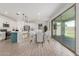 Open-concept kitchen and dining area with a center island and sliding glass doors at 7413 S 32Nd Dr, Phoenix, AZ 85041