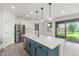 Modern kitchen with stainless steel appliances, center island, and white cabinetry at 7413 S 32Nd Dr, Phoenix, AZ 85041