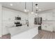 Bright kitchen with white cabinets, stainless appliances, and a quartz countertop island at 7413 S 32Nd Dr, Phoenix, AZ 85041