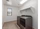 Convenient laundry room with modern washer/dryer, wooden floors and a built-in storage shelf at 7413 S 32Nd Dr, Phoenix, AZ 85041