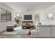 Spacious living room featuring a large television, wood floors and modern décor at 7413 S 32Nd Dr, Phoenix, AZ 85041