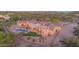 Stunning custom home with a backyard pool and spiral staircase in a desert landscape with mountain views at 8024 E Lone Mountain Rd, Scottsdale, AZ 85266