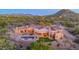 Expansive custom home with a swimming pool, spiral staircase, and lush landscaping in a tranquil desert setting at 8024 E Lone Mountain Rd, Scottsdale, AZ 85266