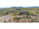 Aerial view of a desert estate featuring mature landscaping, a tile roof, and mountain views at 8024 E Lone Mountain Rd, Scottsdale, AZ 85266