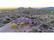 Luxurious desert estate with porte cochere and stone accents in a tranquil landscape with mountain views at 8024 E Lone Mountain Rd, Scottsdale, AZ 85266