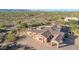 Expansive custom home featuring a portico and a tile roof, surrounded by desert vegetation at 8024 E Lone Mountain Rd, Scottsdale, AZ 85266