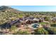 Custom home with a pool, patio, and a tile roof nestled in a mature desert landscape at 8024 E Lone Mountain Rd, Scottsdale, AZ 85266