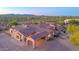 Desert home with a terracotta roof and a stone portico, with beautiful desert and mountain views at 8024 E Lone Mountain Rd, Scottsdale, AZ 85266