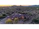 A luxury home is set against a beautiful desert landscape, photographed at twilight at 8024 E Lone Mountain Rd, Scottsdale, AZ 85266