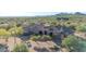 Custom home with a circular tower and large front courtyard nestled in desert landscape at 8024 E Lone Mountain Rd, Scottsdale, AZ 85266