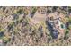 Aerial view of an estate nestled amongst desert vegetation and featuring a resort-style pool at 8024 E Lone Mountain Rd, Scottsdale, AZ 85266