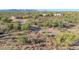 Custom home featuring a long driveway through the desert landscape with mountain views at 8024 E Lone Mountain Rd, Scottsdale, AZ 85266