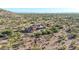 An eye-level aerial view of a home nestled in the Arizona desert, surrounded by lush greenery at 8024 E Lone Mountain Rd, Scottsdale, AZ 85266