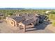 Expansive custom home featuring a portico and a tile roof, surrounded by desert vegetation at 8024 E Lone Mountain Rd, Scottsdale, AZ 85266