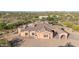 Expansive custom home featuring a portico and a tile roof, surrounded by desert vegetation at 8024 E Lone Mountain Rd, Scottsdale, AZ 85266