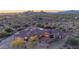 A luxury home is set against a beautiful desert landscape, photographed at twilight at 8024 E Lone Mountain Rd, Scottsdale, AZ 85266