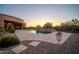 Outdoor living area featuring pool, spa, desert landscaping, and sunset views at 8024 E Lone Mountain Rd, Scottsdale, AZ 85266
