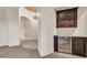 Chic bar area with wine fridge, cabinetry and lighting near an open hallway at 8024 E Lone Mountain Rd, Scottsdale, AZ 85266