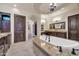Bright bathroom with a luxurious soaking tub, chandelier, and dual vanities at 8024 E Lone Mountain Rd, Scottsdale, AZ 85266