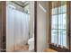 Bathroom with decorative shower curtain and door to the exterior of the property at 8024 E Lone Mountain Rd, Scottsdale, AZ 85266