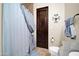 Well-lit bathroom with a tiled shower, wood door, toilet, and granite countertop at 8024 E Lone Mountain Rd, Scottsdale, AZ 85266
