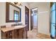 Bathroom featuring dark wooden vanity, tile flooring, and decorative mirror at 8024 E Lone Mountain Rd, Scottsdale, AZ 85266