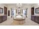 Bright bathroom with a luxurious soaking tub, chandelier, and dual vanities at 8024 E Lone Mountain Rd, Scottsdale, AZ 85266