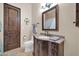 Elegant bathroom featuring a wooden vanity with granite countertop and decorative fixtures at 8024 E Lone Mountain Rd, Scottsdale, AZ 85266