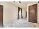 Bedroom with custom marble flooring, neutral paint, wood door, and recessed lighting at 8024 E Lone Mountain Rd, Scottsdale, AZ 85266