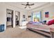 Bedroom with wood bed frame, adjacent bathroom, and walk-in closet at 8024 E Lone Mountain Rd, Scottsdale, AZ 85266