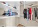Well-organized closet with clothing racks, upper shelves, and personal items at 8024 E Lone Mountain Rd, Scottsdale, AZ 85266