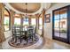 Charming dining area with large windows showcasing scenic views and an elegant chandelier at 8024 E Lone Mountain Rd, Scottsdale, AZ 85266