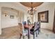 Elegant dining room with tray ceiling, chandelier and travertine floors at 8024 E Lone Mountain Rd, Scottsdale, AZ 85266