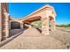 A circular driveway leading to a portico and garage in a desert landscape at 8024 E Lone Mountain Rd, Scottsdale, AZ 85266