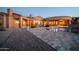 Beautiful desert home featuring a pool, large patio, and stylish architectural design in the evening at 8024 E Lone Mountain Rd, Scottsdale, AZ 85266