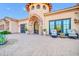The luxurious home entrance features a stunning circular tower and beautiful stonework at 8024 E Lone Mountain Rd, Scottsdale, AZ 85266