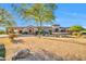 Stunning home displaying desert landscaping, rock features, and a circular tower at 8024 E Lone Mountain Rd, Scottsdale, AZ 85266